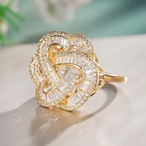 Macro shot of luxury gold flower ring featuring baguette-cut stones and pave zircons