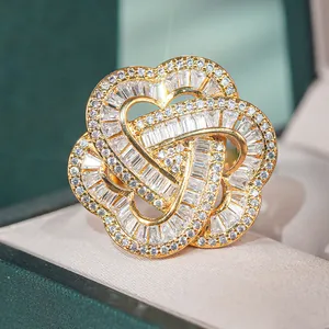 Macro view of a gold flower ring featuring petal geometry and pave-set white cubic zirconia