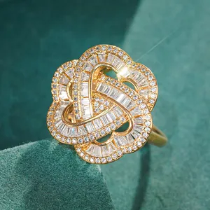 Detailed macro view of gold-plated three-heart ring with pavé-set crystals and T-square cuts