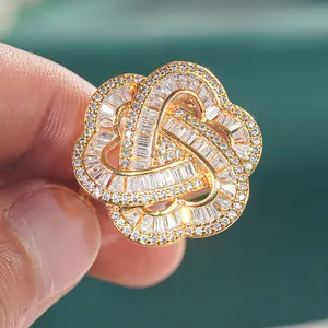Macro shot of gold floral ring featuring round and baguette-cut cubic zirconia stones