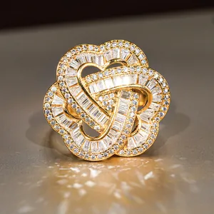 Gold statement ring with sparkling heart and clover motifs set in micro-pave cubic zirconia
