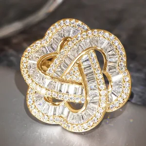 Macro shot of gold intertwined ring with baguette-cut and round-cut zircons on stone
