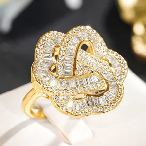 Detailed close-up of a luxury gold flower ring with intricate pave zircon settings