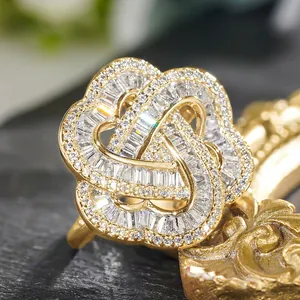 Macro close-up of intricate flower ring with pave-set crystals on dark stone
