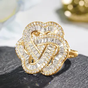 Macro shot of gold plated floral ring with heart accents and pavé set cubic zirconia