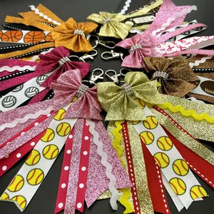 Sparkly sports bow keychains with glitter ribbons and cheer prints on gray background