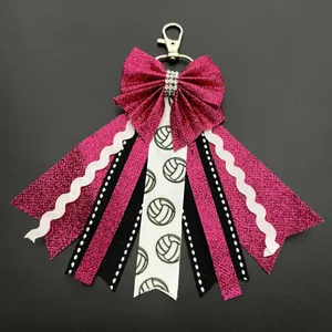 Handmade pink sequin bow keychain with volleyball ribbons and silver lobster clasp