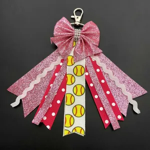 Detail showing pink glitter bow with softball pattern ribbons and silver lobster clasp