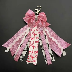 Pink glitter cheer bow keychain with soccer print and pink ribbon awareness charm
