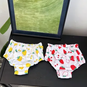 Detailed view of dog physiological pants with fruit prints and decorative back bows