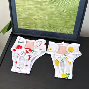 Detail of strawberry print dog sanitary pants with tail hole and velcro closure