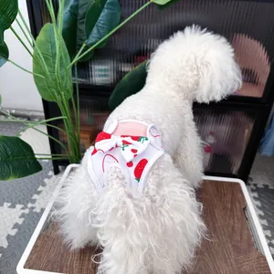 Detailed view of white cotton dog diaper with red strawberry prints and a cute bow