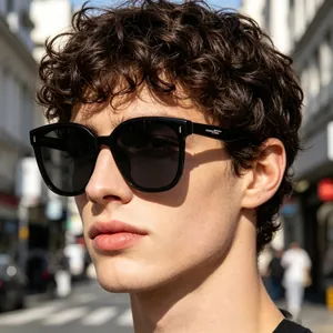 Detailed close-up of stylish men's black square frame polarized sunglasses on model