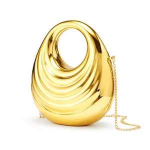 Golden acrylic evening handbag with shell texture and metal chain strap for women