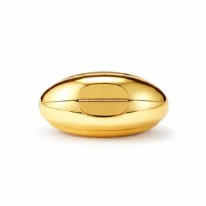 Detail of the high-gloss gold mirror finish and oval geometry of this luxury evening clutch