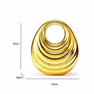 Polished gold abstract vase with ripple texture, dimensions 27cm height by 22cm width