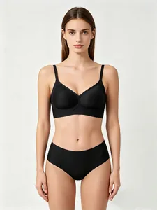 Detail of seamless black wireless bra set with jelly-strip support and matching panties