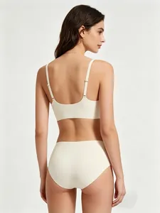 Detail of seamless beige bra set with thin straps and U-shaped back design for women