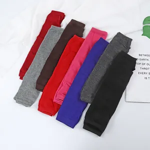 Knitted fingerless wrist warmers with thumb holes available in eight solid colors