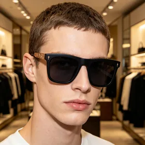 Detail of square black sunglasses for men featuring vintage gold embossed temple patterns