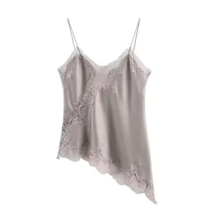 Detailed view of silver satin camisole with intricate lace trim and asymmetrical hem