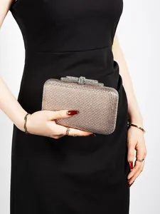 Detail of elegant champagne gold rhinestone clutch bag with a unique knot clasp
