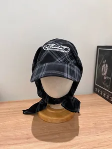 Close-up of freedom embroidery and plaid fabric texture on a cotton headscarf cap