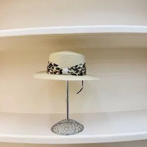 Flat top beige straw boater hat with leopard print ribbon and pearl embellishment