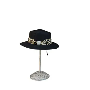 Flat top straw sun hat in black with leopard print ribbon and pearl buckle accent