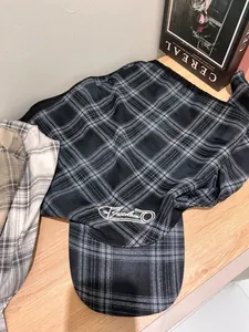 Detail of plaid sun hat with neck protection flap and Freedom letter embroidery