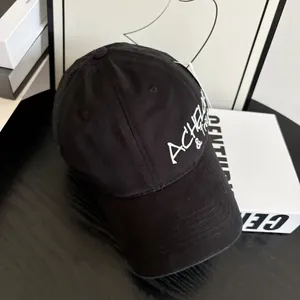 Detail of ACHEL white embroidery on black distressed canvas baseball cap with vent holes