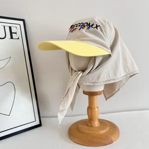 Beige sun hat with yellow brim and neck flap featuring colorful freedom embroidery