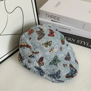 Retro light blue flat cap with colorful butterfly jacquard pattern for a vintage look