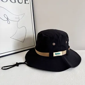 Detail of waterproof black sun hat with breathable eyelets and adjustable wind cord