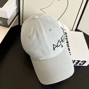 Detail of embroidered letters on grey canvas baseball cap with reinforced stitching