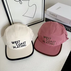 Japanese style five-panel baseball caps in beige and dusty pink with West Coast embroidery