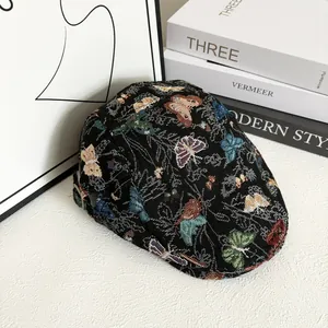 Close-up of ivy cap with colorful butterfly jacquard and adjustable metal buckle