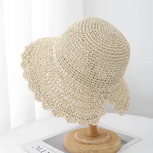 Foldable handmade straw sun hat with wavy brim for women beach vacation in beige