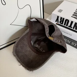 Detail of distressed brim and 100% cotton fabric on vintage brown baseball cap