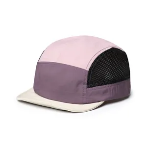 Detail view of quick-dry five-panel cap featuring mesh vents and multicolor patchwork design