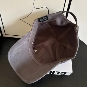 Detailed interior of dark gray cotton baseball cap showing quality stitching and washing label