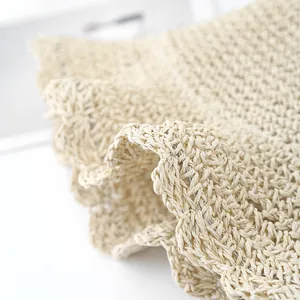 Macro shot of wavy handmade crochet straw weave showing detailed natural fiber texture