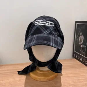 Fashionable black and grey plaid headscarf hat with Freedom embroidery on a model