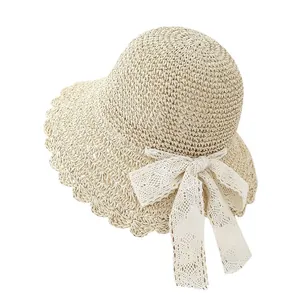 Handwoven straw sun hat with wavy lace trim and bow for summer beach protection