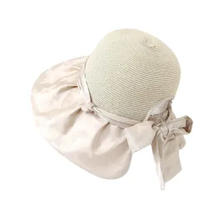 Elegante cappello da sole in paglia beige da donna con grande fiocco e bordo in raso
