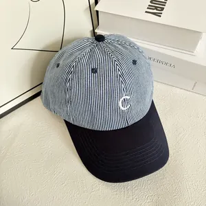 Close-up of blue and white striped cotton cap with white C letter embroidery
