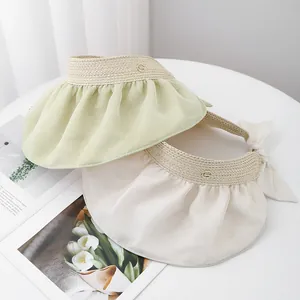 Women summer sun hat with large pleated brim and elegant bow tie in light green and beige