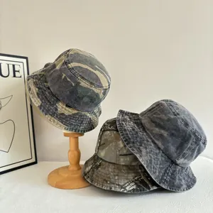 Vintage washed camouflage bucket hats in forest green, dark grey and earth brown colors