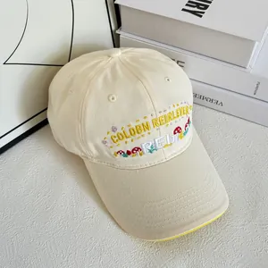 Close-up of cute mushroom and letter embroidery on cream cotton baseball cap