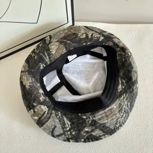 Close-up of camouflage sun hat interior featuring black sweatband and care label details